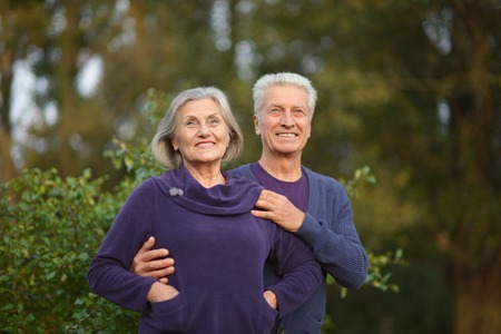 Portrait of a senior couple in autumn parkの写真素材