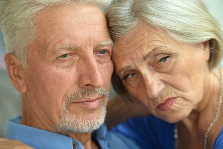 Portrait of a sad senior couple at home
