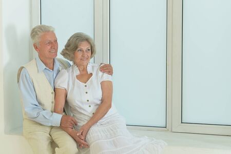 Portrait of beautiful mature couple sitting nearの写真素材