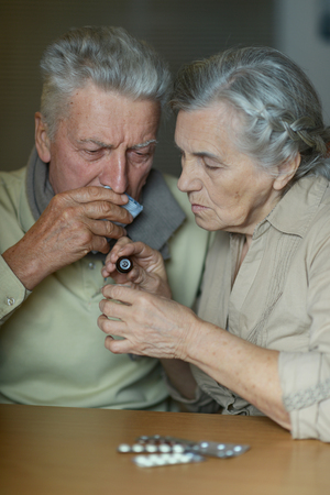 Elderly caucasian couple ill with influenza at homeの写真素材