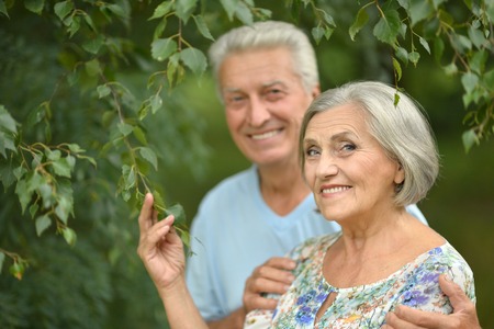 Loving mature couple on a walk in the park in summer