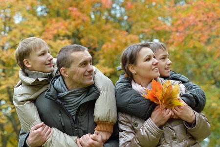 Portrait of family relaxing in autumn parkの写真素材