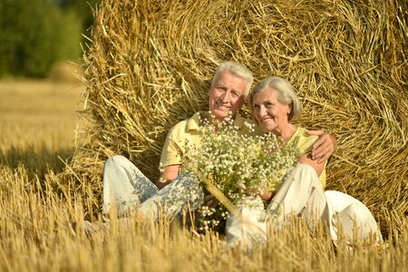 Portrait of a beautiful senior couple  in summer fieldの写真素材