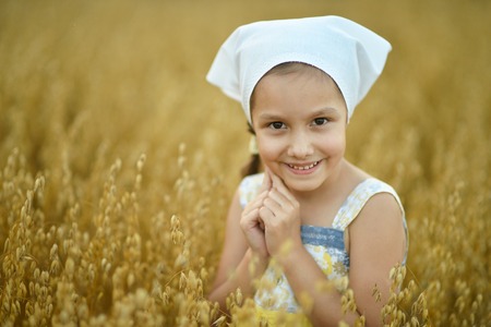 Cute little  girl in the wheat fieldの写真素材