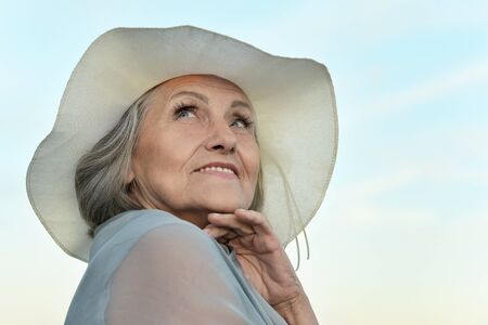 Portrait of a beautiful senior woman on a background of  skyの写真素材
