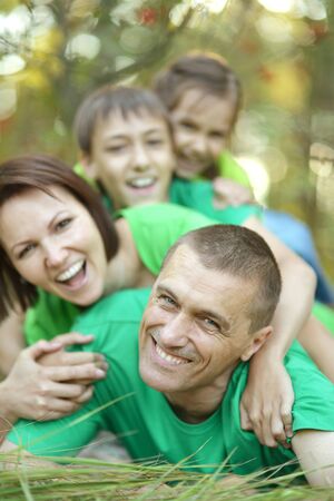 Happy Family resting in a summer parkの写真素材
