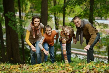 Portrait of family relaxing in autumn parkの写真素材