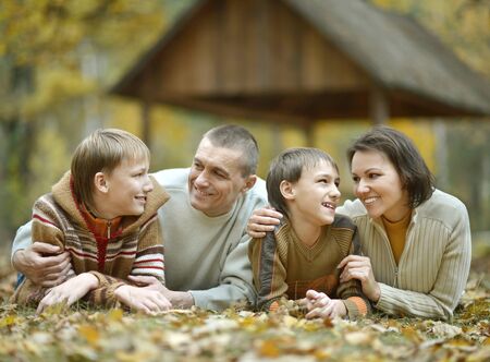 Nice happy family relax in the autumn park