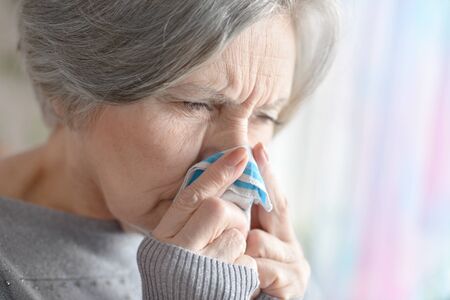 Happy senior couple in autumn park close-upの写真素材
