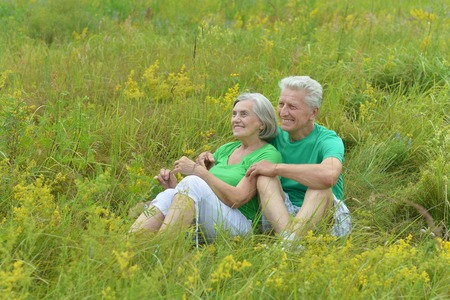 Happy mature couple hugging in green summer parkの写真素材