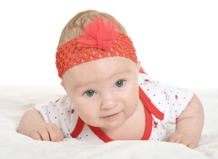 Adorable baby girl in cute clothes on blanketの写真素材
