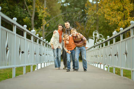 Portrait of a happy family relaxing in autumn parkの写真素材