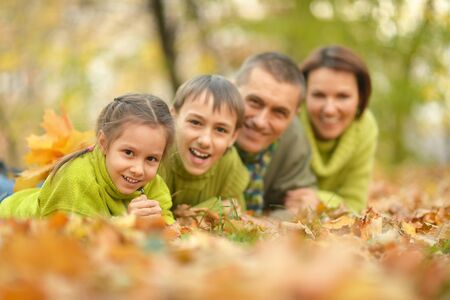 Happy Family resting in a autumn park