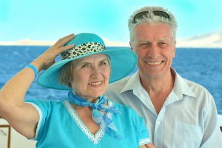 Active smiling senior couple exercising in gym