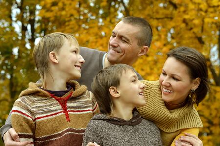 Portrait of family relaxing in autumn parkの写真素材