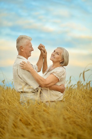 Senior couple resting at summer field  during vacationの写真素材