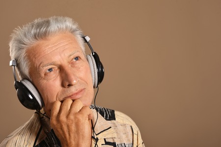 Portrait of a senior man listen music in headphonesの写真素材