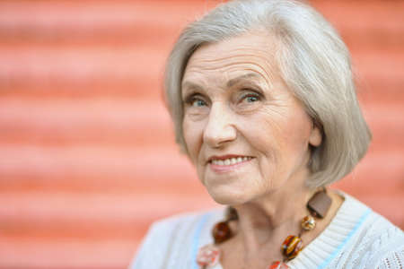 Portrait of a mature woman near wall on streetの写真素材