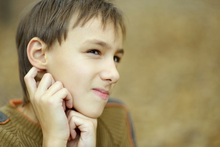 Portrait of happy boy in autumn parkの写真素材
