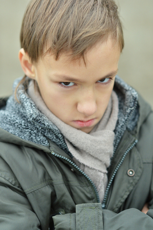 Portrait of a little sad boy in autumn parkの写真素材