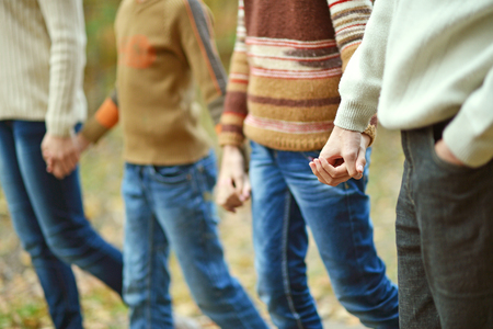 Portrait of happy family walking in autumn parkの写真素材