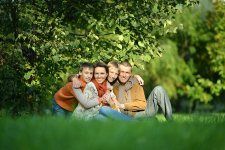 Portrait of family relaxing in autumn park