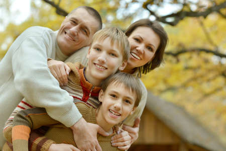 Portrait of family relaxing in autumn park
