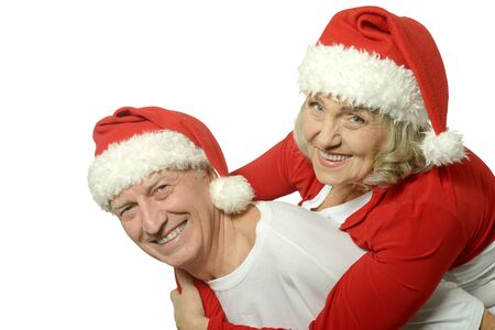 Happy beautiful elderly couple celebrating new year on white backgroundの写真素材