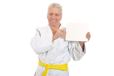 Karate Senior man with white poster on white backgroundの写真素材