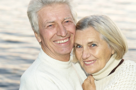 Portrait of a happy cute senior couple at seaの写真素材