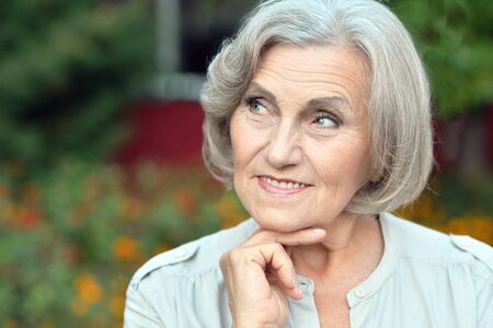 Portrait of a senior woman in summer park