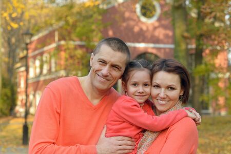 Happy smiling family relaxing in autumn parkの写真素材