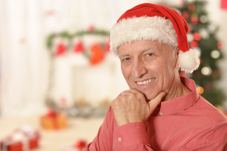happy senior man wearing Christmas holiday capの写真素材