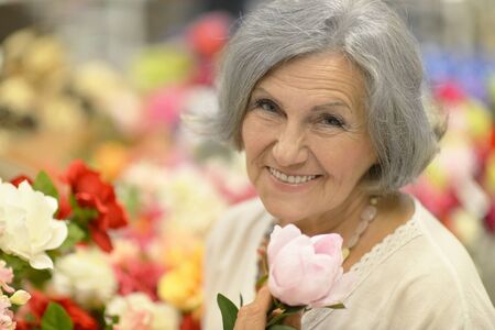 Portrait of a beautiful older woman with flowers