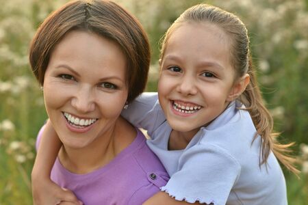 Little cute girl with mother in park