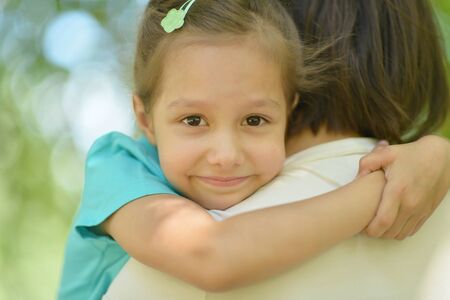 Little cute girl with mother in parkの写真素材