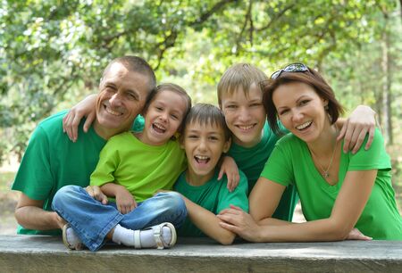 Happy family resting in a summer park