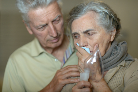 Portrait of elderly man and woman with flu inhalationの写真素材