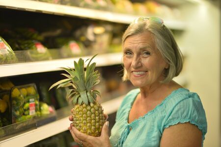 Happy beautiful senior woman in a marketの写真素材