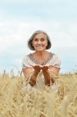 Portrait of a senior woman in summer fieldの写真素材