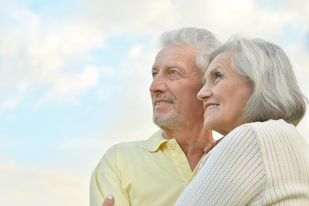beautiful elderly couple  on the background of sky