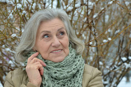 Portrait of a beautiful old woman in the winter