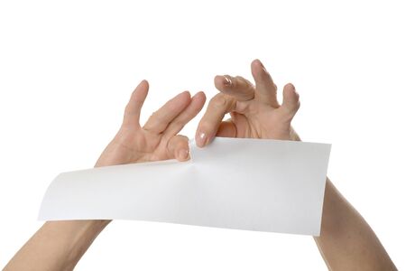 Hands tearing paper sheet, closeup on white backgroundの写真素材