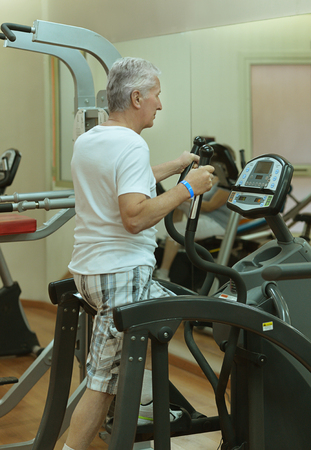 Elderly man in a gym during exerciseの写真素材