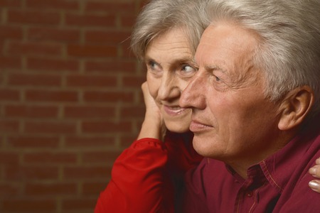 Portrait of a mature couple near wall on streetの写真素材