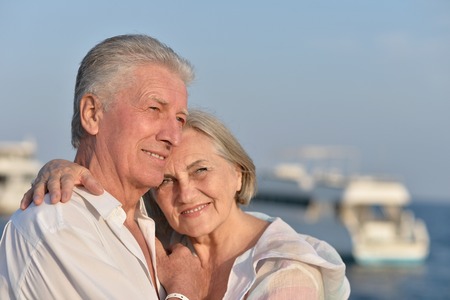 Portrait of a happy cute senior couple at seaの写真素材