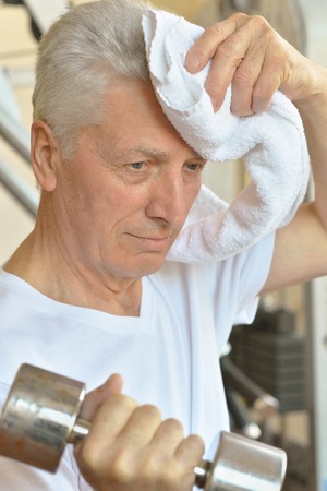 Elderly man in a gym during exerciseの写真素材
