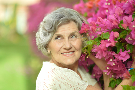 Portrait of beautiful senior woman outdoor in summer parkの写真素材