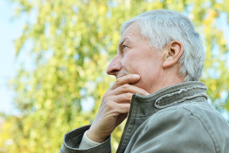 Portrait of thoughtful elderly man in autumn
