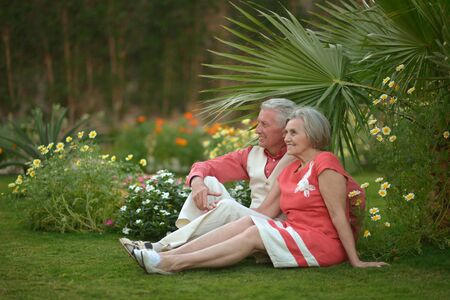 Happy elderly couple   in tropical garden outdoorの写真素材